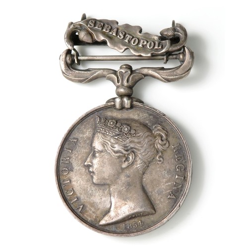 135 - Silver Crimea medal with Sebastopol clasp. Stamped around the edge N03388. EDWIN. HARDEN. 19TH. REGT... 