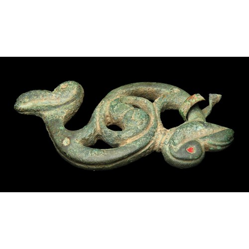 4 - Dragonesque brooch. Circa 1st-2nd century AD. Copper-alloy, 57mm x 32mm, 24.9g. An S-shaped open-wor... 