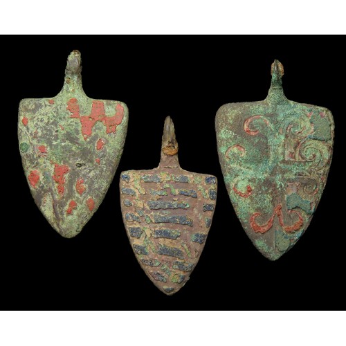 76 - Medieval heraldic pendant group. Circa 13th-14th century AD. Copper-alloy, largest 46mm x 28mm. Thre... 