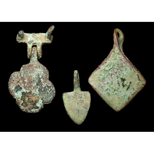 78 - Medieval heraldic pendant group. Circa 13th-14th century AD. Copper-alloy, largest 38mm x 21mm. Thre... 