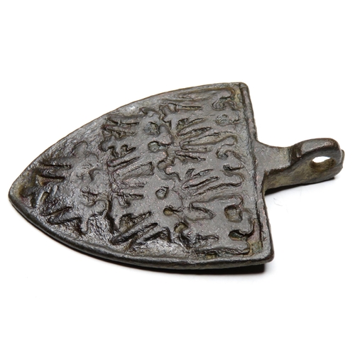 1064 - Medieval heraldic harness pendant. Circa 13th century AD. Copper-alloy, 11.59g. 42.99 mm. A shield-s... 