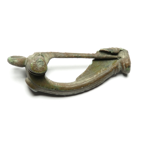 1035 - Roman headstud type brooch, c. 2nd century AD. The brooch is has short wings with a chain loop and i... 