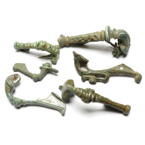 1039 - Roman brooch group including five trumpet type brooches and a T-shaped brooch with enamel. 1st - 2nd... 