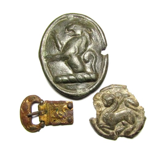 117 - Artefact Group. Circa 12th-18th century AD. 30 mm - 51 mm. To include, a lead-alloy disc brooch or m... 