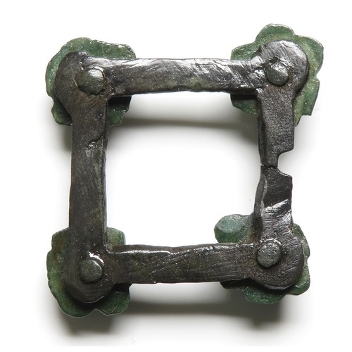 118 - Medieval brooch. A  medieval open-framed brooch of square form with a stylised repousse flower attac... 