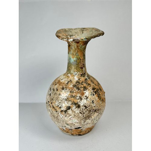 67 - Roman Glass Flask. Circa 1st-2nd century CE. 100mm x 56mm. A beautifully well preserved glass vessel... 