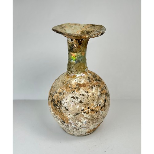 67 - Roman Glass Flask. Circa 1st-2nd century CE. 100mm x 56mm. A beautifully well preserved glass vessel... 