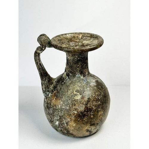 68 - Roman Glass Juglet. Circa 3rdcentury CE. 77mm x 54mm. A beautifully well preserved glass vessel form... 