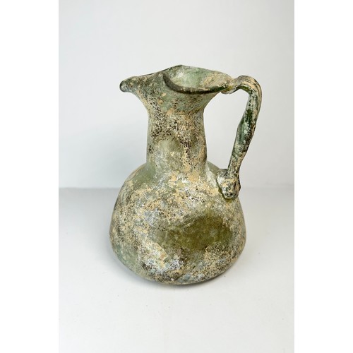 69 - Roman Glass Juglet. Circa 3rd / 4th century CE. 84mm x 72mm. A beautifully well preserved glass vess... 