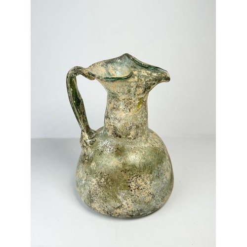 69 - Roman Glass Juglet. Circa 3rd / 4th century CE. 84mm x 72mm. A beautifully well preserved glass vess... 