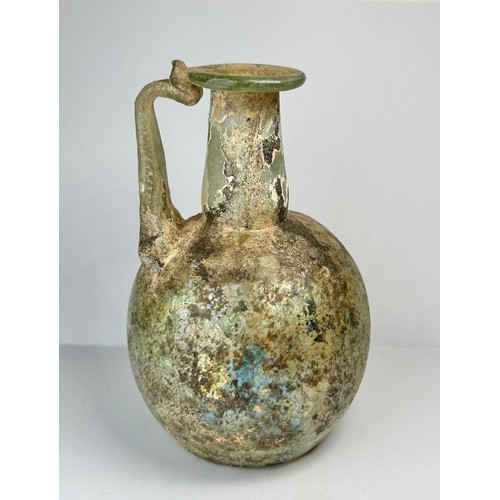 70 - Roman Glass Single Handled Flask. Circa 4th century CE. 110mm x 72mm. A beautifully well preserved g... 