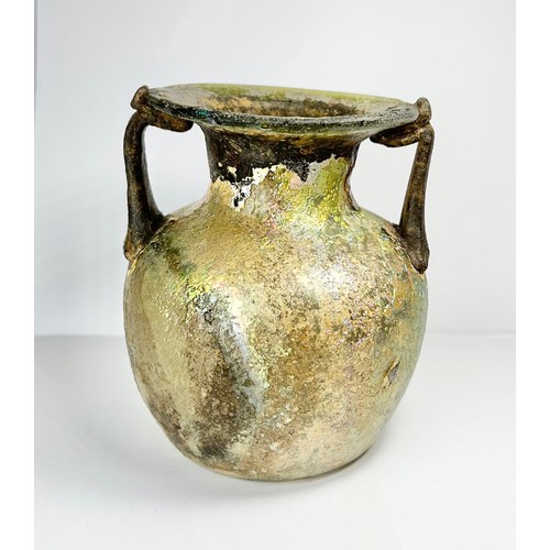 71 - Roman Glass Twin Handled Flask. Circa 3rd / 4th century CE. 98mm x 82mm. A beautifully well preserve... 