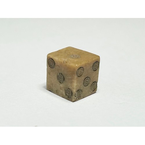 90 - Roman Bone Gaming Die. Circa 1st-3rd century CE. 9mm x 8mm 1.74g. Numbered on each face with incised... 