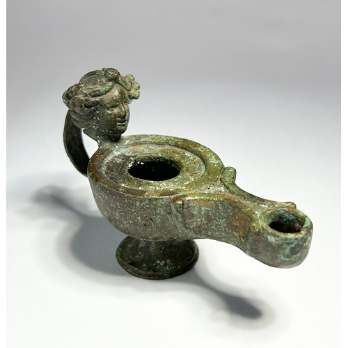 64 - Greco Roman Oil Lamp. Circa 1st century CE. Copper-alloy, 93mm x 37mm 130.40 grams. An impressive br... 