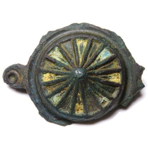 82 - Roman umbonate brooch. Circa 2nd century CE. Copper-alloy, 42mm, 11.5g. A spoked wheel form with pan... 