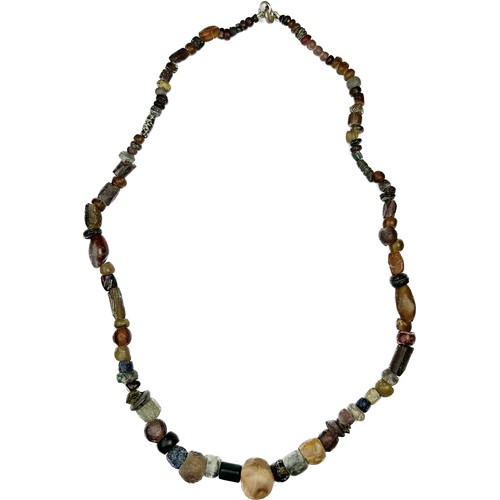 103 - Anglo-Saxon Stone and Glass Bead Necklace. Circa 7th-9th century CE. Length, 470 mm. Beads in variou... 