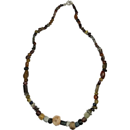 103 - Anglo-Saxon Stone and Glass Bead Necklace. Circa 7th-9th century CE. Length, 470 mm. Beads in variou... 