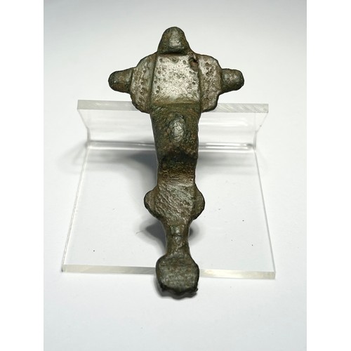 119 - Anglo Saxon Brooch. Circa 6th century CE. A cruciform type detailed with punched decoration. Copper-... 