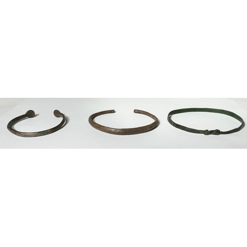 121 - Ancient British Bangles, Circa 2nd-10th century CE. A Group of three with various forms of decoratio... 