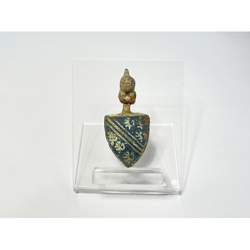 141 - Medieval Heraldic Pendant. Circa 13th-14th century CE. A gilt bronze shield-shaped pendant with blue... 