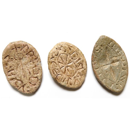 146 - Three medieval lead seal matrices. Oval and Vesica-shaped seals, all personal with central motifs. L... 