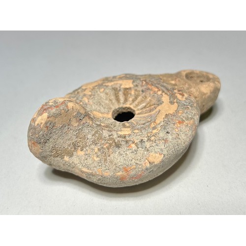 17 - Roman Terracotta Oil Lamp. Circa 1st-3rd century CE. 86 x 54 mm. Decorated with a concave circular p... 