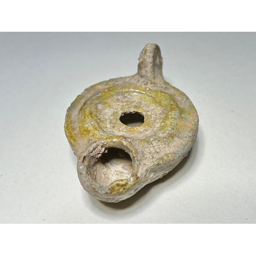 18 - Roman Green Glazed Pottery Oil Lamp. Circa 2st-5th century CE. 82 x 58 mm. Detailed with a wide rais... 