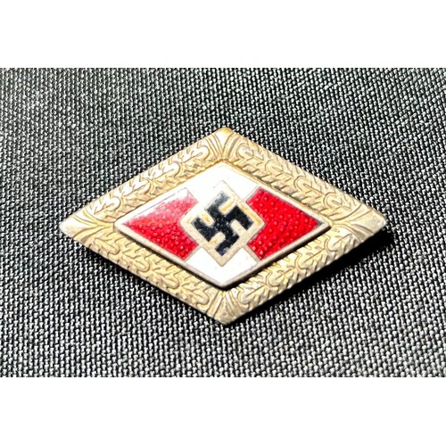 73 - Military Group, WWII German badges (2). Lozenge shaped enamel party badge and a military issue displ... 