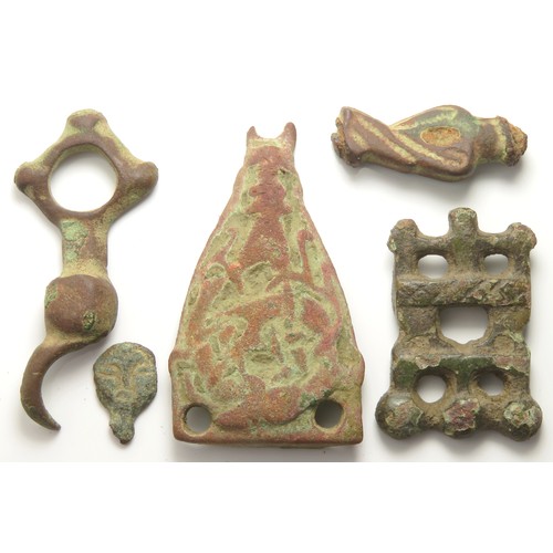 37 - Viking artefact group including a stirrup mount, bridle mount and strap end. C. 11th century, larges... 