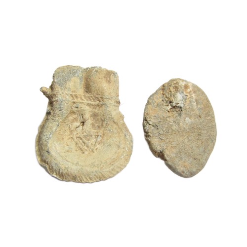 59 - Medieval Artefacts Group (2). To include, a lead seal matrix detailed with a central floral device w... 