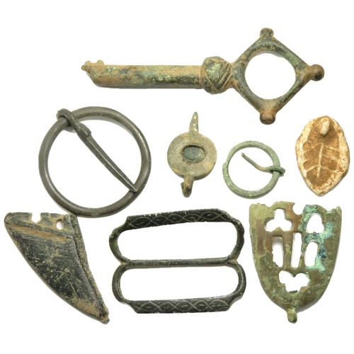 61 - Medieval artefact group including a large key, two scabbard chapes, three buckles and a lead seal ma... 