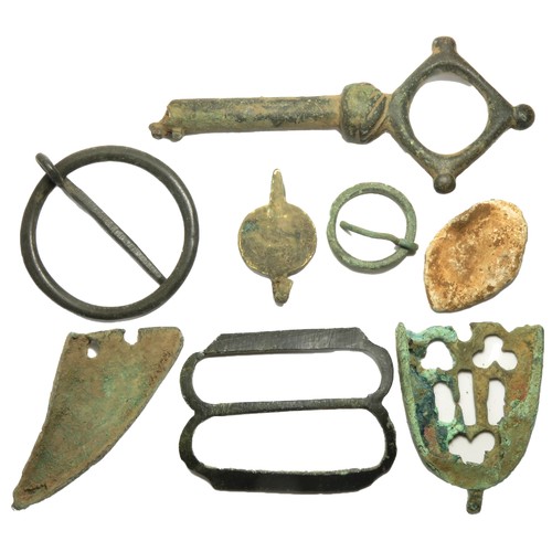 61 - Medieval artefact group including a large key, two scabbard chapes, three buckles and a lead seal ma... 