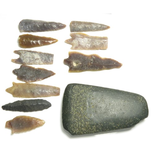 15 - Stone axehead and flint arrowhead group. A varied collection including a polished greenstone axehead... 