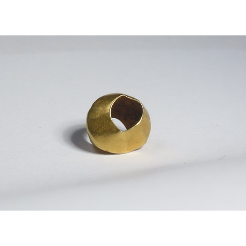 21 - Bronze Age gold bead. Circa 1500-1100 BCE. 0.56g. 10mm. A biconical bead with slightly dished, conca... 