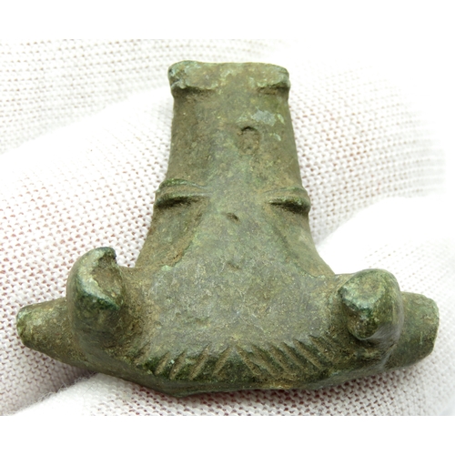 23 - Late Iron Age / Roman bull's head mount. Circa 1st-2nd century CE. Copper-alloy, 30x36mm. A vessel m... 