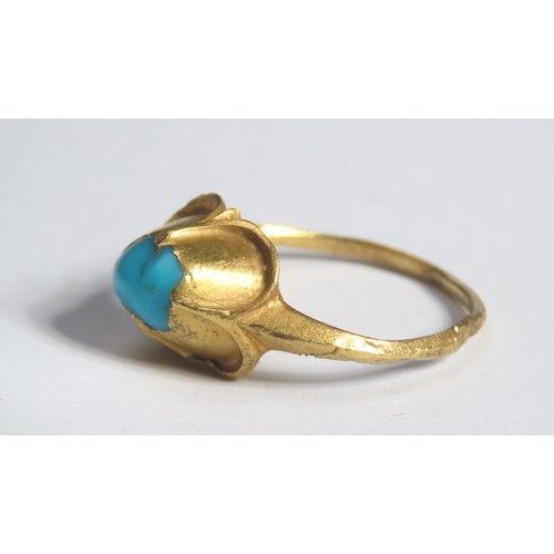 68 - Medieval gold and turquoise ring. Circa 16th century CE. A high carat yellow gold finger ring with a... 