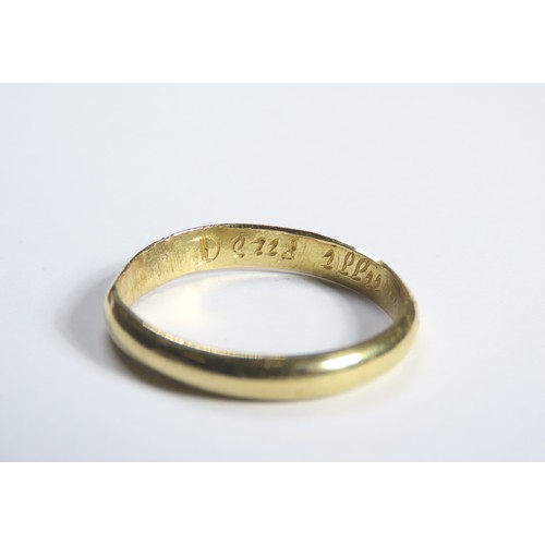 73 - Gold Momento Mori Finger Ring. Circa 1700 CE. A plain band engraved with a stylised skull and inscri... 