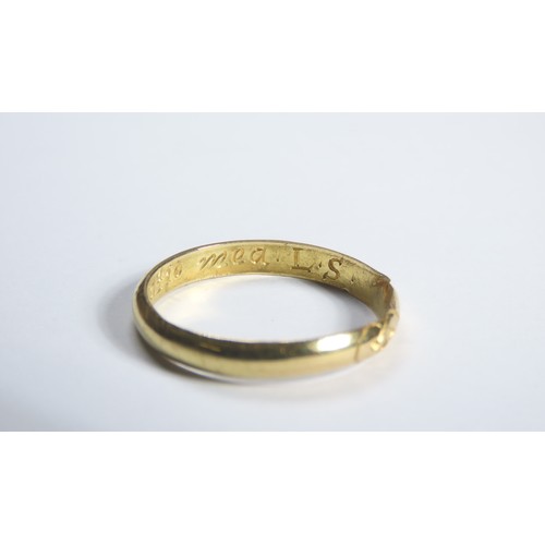 73 - Gold Momento Mori Finger Ring. Circa 1700 CE. A plain band engraved with a stylised skull and inscri... 