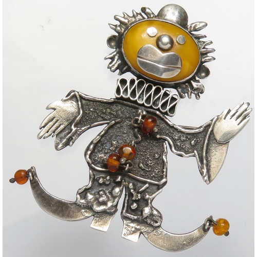 81 - Silver and amber clown brooch. 70mm, 20g.