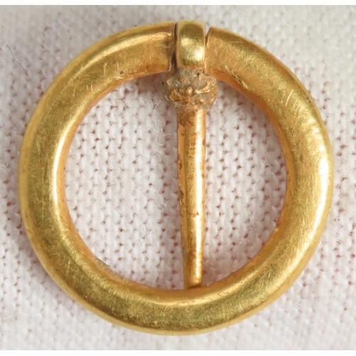 67 - Medieval Gold Annular Brooch. Circa 1200-1350 CE. 14mm, 1.32g. The face of the brooch is decorated w... 