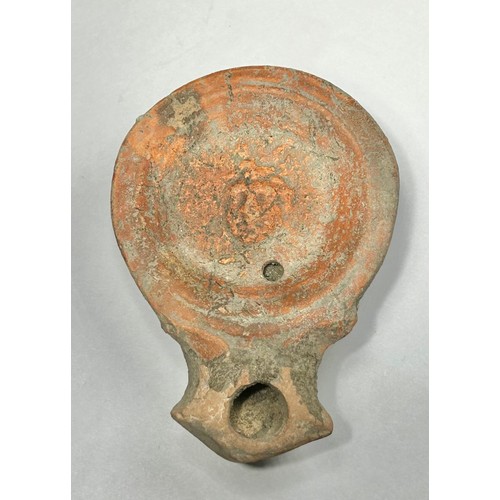 116 - Roman Terracotta oil lamp. Loeschcke type I C, circa 1st century AD. A Mold made type, filling-hole ... 