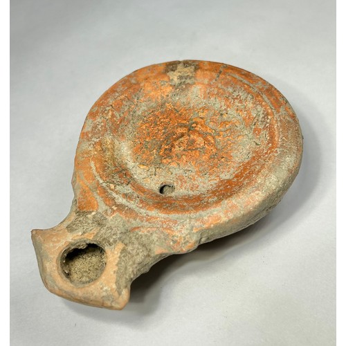 116 - Roman Terracotta oil lamp. Loeschcke type I C, circa 1st century AD. A Mold made type, filling-hole ... 