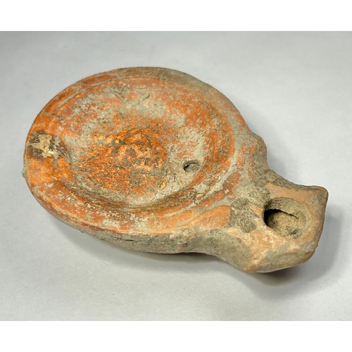 116 - Roman Terracotta oil lamp. Loeschcke type I C, circa 1st century AD. A Mold made type, filling-hole ... 