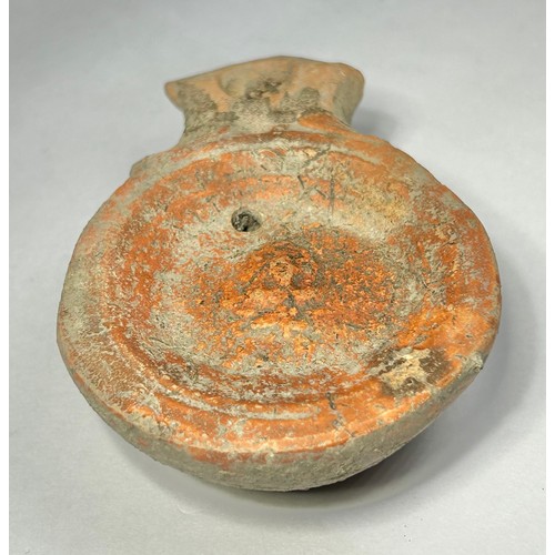 116 - Roman Terracotta oil lamp. Loeschcke type I C, circa 1st century AD. A Mold made type, filling-hole ... 