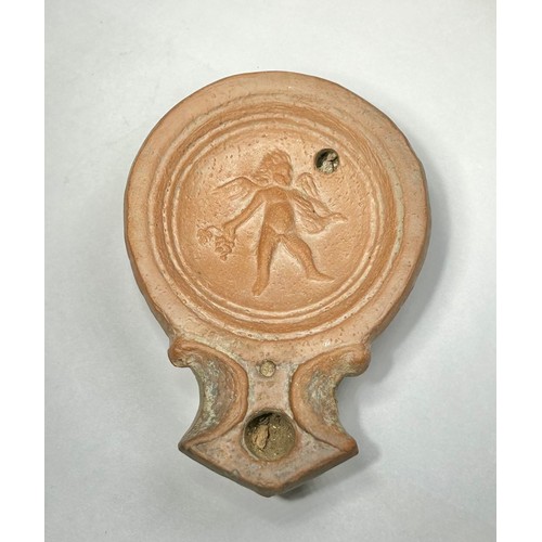 117 - Roman Terracotta oil lamp. Loeschcke type I C, circa 1st century AD. A Mold made type, filling-hole ... 