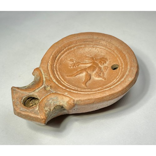 117 - Roman Terracotta oil lamp. Loeschcke type I C, circa 1st century AD. A Mold made type, filling-hole ... 