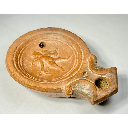 117 - Roman Terracotta oil lamp. Loeschcke type I C, circa 1st century AD. A Mold made type, filling-hole ... 