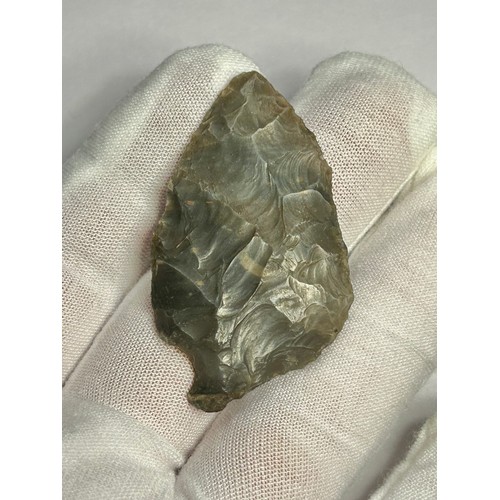 96 - Neolithic leaf-shaped flint arrow-head. Circa 3500 BCE. 50mm x 29mm. Knapped from a piece of dark br... 