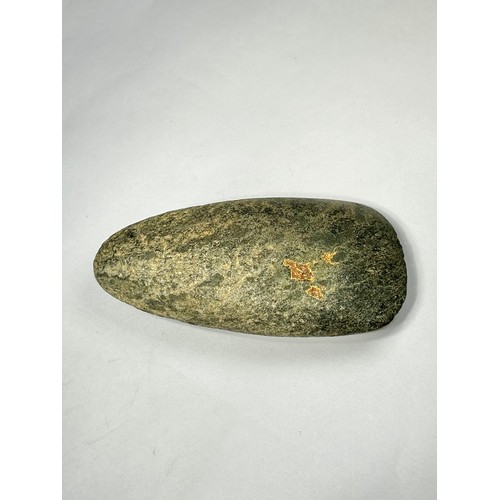 98 - A Cornish Neolithic polished green stone axe. Circa 5000 BCE. 91mm x 48mm. Complete and undamaged wi... 