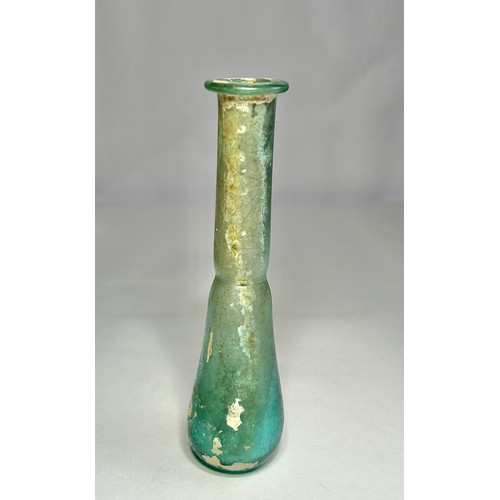 118 - Roman Glass Unguentarium. Circa 1st-2nd century CE. 126mm. A blue/green glass bottle with an elongat... 